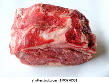 Top Angle View Of Raw Prime Rib Roast With Cap Off. Isolated On White