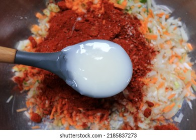 Top Angle View Of White Rice Starch On Scoop To Make Kimchi Seasoning With Chili Powder And Ingredients In A Stainless Bowl, South Korea 
