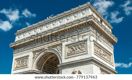 Top of the Arc de Triomphe (Triumphal Arch of the Star) timelapse is one of the most famous monuments in Paris, standing at the western end of the Champs-Elyseees. Blue cloudy sky at summer day