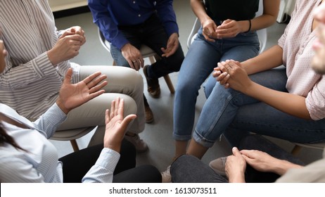 Top close up view in circle sit people, corporate teambuilding activity solve issues talk think together or alcohol rehab addiction treatment, twelve-step program, physical, mental, spiritual concept