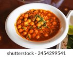 Top closeup view of chole masala or chana an indian street food made of chickpeas, tomatoes and cumin.