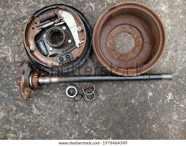 Top corner of\
the drum brake unit And the side axle for driving the rear wheel of\
the car placed on the\
ground