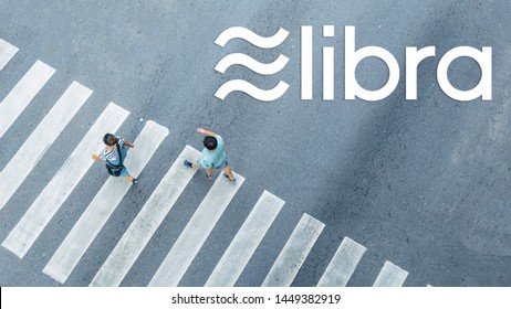 The From The Top Crosswise View Of People Walk On Street Pedestrian Crossroad In The City Street ,bird Eye View.With Libra Logo Blockchain Digital Currency And Cryptocurrency.