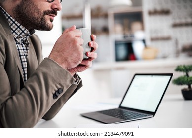 Top Cut Half Mid Section Of Adult Young Man Enjoying, Holding A Cup Of Coffee, Tea Or Other Drink While Taking A Break From Work.
Focus On Hands An Cup.
