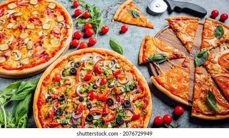 Top dow flat lay view on pizzas with fresh eco ingridients on rustic background, Pizza shop table