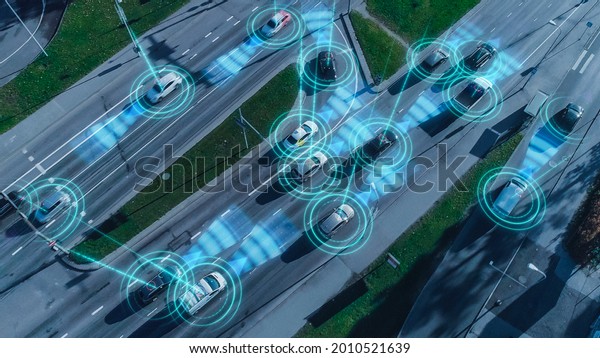 Top Down Aerial Drone: Autonomous Self Driving\
Cars Moving Through City. Concept: Artificial Intelligence Scans\
Surrounding Environment, Detecting Cars, Avoids Traffic Jams and\
Drives Safely.