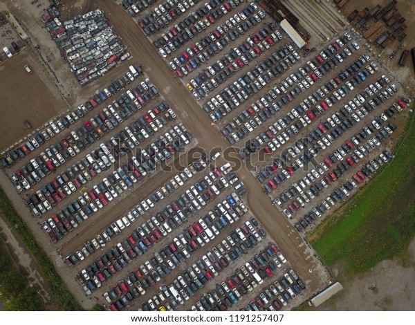Top down aerial drone image of a junk yard
with row after row of wrecked
cars.