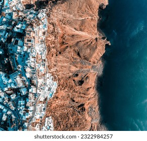 Top down aerial image of the Greek city Fira on the edge of the Caldera cliff on Santorini - Powered by Shutterstock