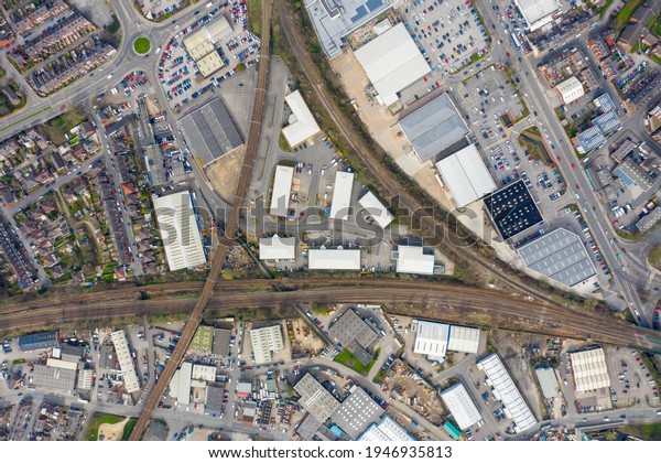 Top down aerial photo of the British town\
of Wakefield in West Yorkshire in the UK showing train tracks that\
are crossing taken in the spring\
time