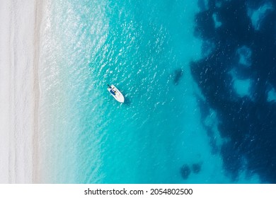 Top Down Aerial View Of Boat At Fteri Beach On The Greek Island Of Kefalonia, Ionian Sea Greece. Turquoise Colored Water And Remote Beach