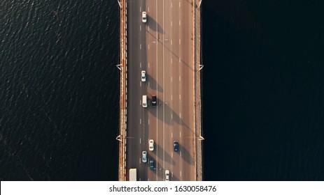 Top Down Aerial View Of Car Traffic On Bridge Over River, Drone Shot.