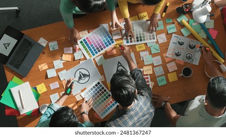 Top down aerial view of designer looking at logo while project manager choosing color palettes. Time lapse of skilled graphic designing and looking at logo. Skilled team choosing graphic. Symposium. - Powered by Shutterstock