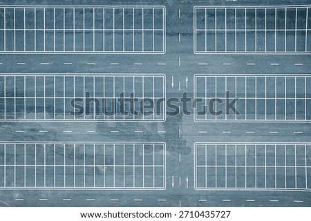 Top down aerial view of empty asphalt parking lot with white lines background.