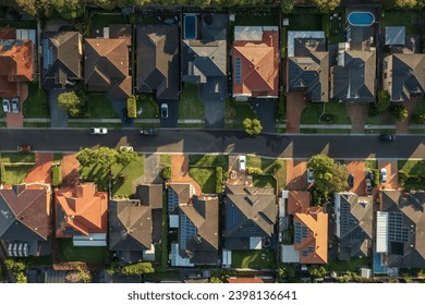 Top down aerial view of a neighbourhood street lined with upmarket houses in outer suburban Sydney, Australia.