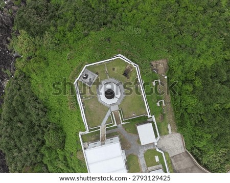 Top down aerial view of an octagonal lighthouse compound.
