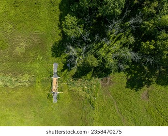 A top down, aerial view over the hills of Salisbury Mills, NY on a beautiful and sunny day with a small wooden foot bridge in view, Taken with a drone camera. - Powered by Shutterstock