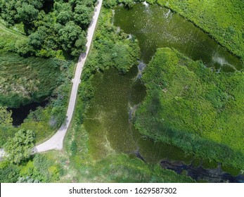 Top Down Aerial View Of Oxbow Lake. Muddy Water Next To Swamps