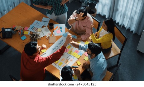 Top down aerial view of professional business people hands making scrum task board to manage workflow in workplace. Diverse marketing team clapping hands to celebrate successful project. Convocation. - Powered by Shutterstock