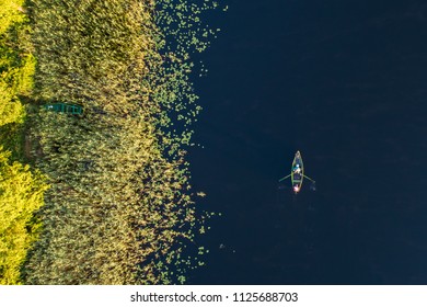 Top Down Aerial View Of Small Rowing Boat Near Coast Of Lake In Moletai Region, Lithuania