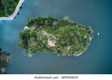 Top Down Aerial View Of Small Green Island In A Blue Lake