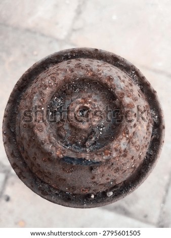 Top down close up macro of an old abandoned spray paint can with extreme rust and corrosion. Detailed weathered metal texture with peeling surface and grunge details. Perfect for industrial backgrounds and design elements.