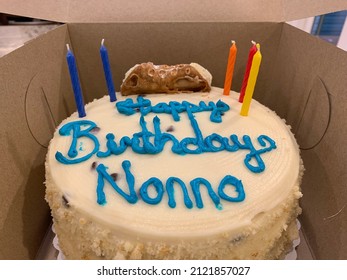 The Top Down, Close Up View Of A Birthday Cake That Is Still In The Cardboard Box From The Bakery. The Cake Reads 