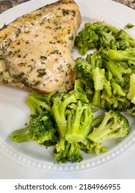 The Top Down, Close Up View Of Freshly Cooked Swordfish Steak Served With A Side Of Fresh Broccoli.