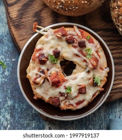 Top Down Close Up View Of A Homemade Chorizo Pizza Bagel On A Wooden Board.