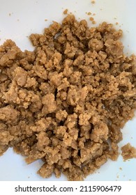 The Top Down, Close Up View Of Raw, Homemade Crumb Topping Made Of Flour, Butter, And Brown Sugar. It's In A White, Plastic, Mixing Bowl.