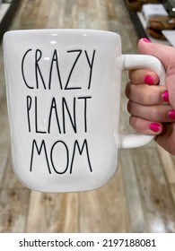 The Top Down, Close Up View Of A Woman Holding A Coffee Mug That Reads 