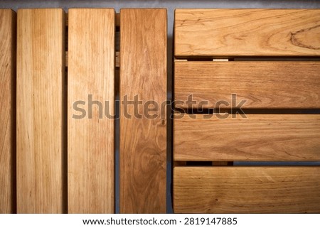 Top down detailed close up view of warm golden brown alder wood planks on sauna bench showcasing natural organic grain patterns, smooth texture, horizontal lines, vertical stripes, clean joinery