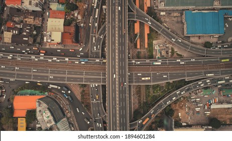 Top down of downtown traffic road at cityscape urban scenery in aerial view. Car park at high buildings, freeway with cars and trucks. Local transportation of Philippine capital Manila town drone shot