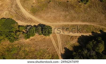 Top down drone areal view on countryside road in the field