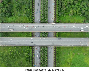 Top down drone image of elevated highway crossing with parallel carriageways and landscaped median near Dong Anh District in Hanoi.