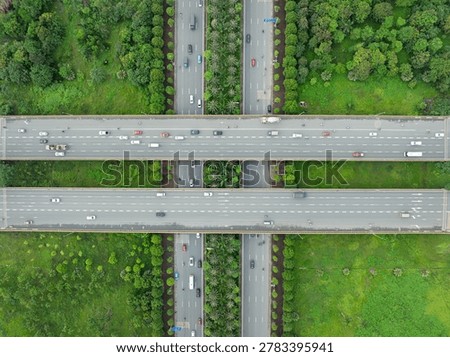 Top down drone image of elevated highway crossing with parallel carriageways and landscaped median near Dong Anh District in Hanoi.