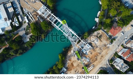 top down drone photo of river and bridge construction site 