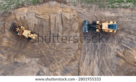 Top Down Drone View of Wheel Loader and Motor Grader Working on Residential Earthworks Construction Site