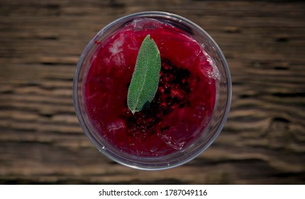 Top Down Flat Lay View Of Glass Full Of Traditional Native American Herbal Blackberry Sage Ice Tea With Fresh Berries And Sage Leaf, At A Powwow