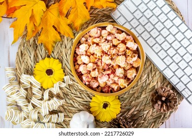 Top Down Flatlay For Autumn Snacking, Office And Work Concepts. Bowl Of Flavored Popcorn, With. Maple Leaves, Keyboard, Pine Cones And Sunflowers