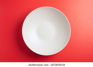 Top Down Minimalist View Of A White Bowl On Yellow Background. White Round Plate On Red Background