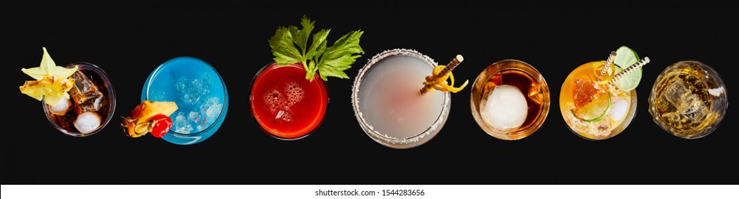 Top Down Panorama Banner Or Header Of A Variety Of Different Colorful Exotic Alcoholic Cocktails Garnished With Fruit Served In Glasses Over A Black Background For Advertising