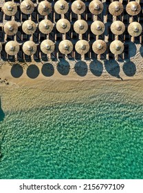 Top Down Photo Of A Beach Club In Mykonos With Crystal Clear Water In Greece During Summer