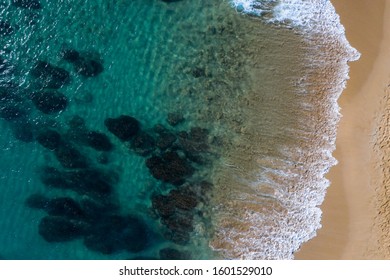 Top down Reef beach drone shot rocky coral reef cristal clear blue water ocean sea