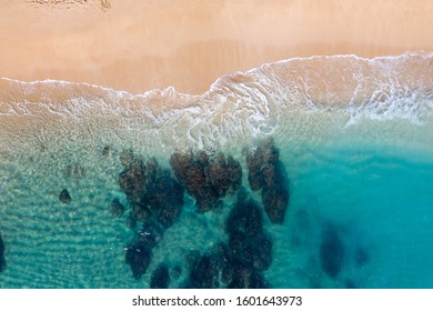 Top down Reef beach drone shot rocky coral reef crystal clear blue water ocean sea
