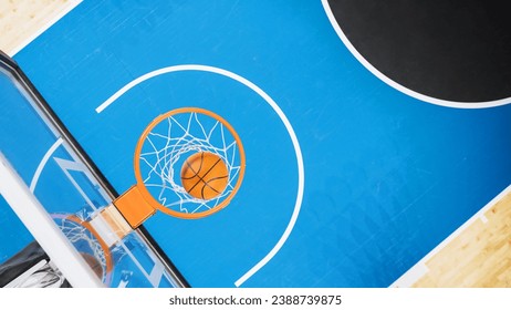 Top Down Shot Of Basketball Ball Going Through a Hoop At Sports Court In International Arena. Empty Playing Field Where Professional Matches And Games Are Held Awaiting For Begining Of Tournament. - Powered by Shutterstock