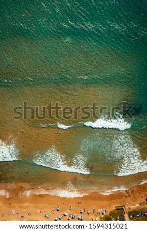 Similar – Luftaufnahme Panoramadrohne Blick auf den blauen Ozean Wellen, die am Sandstrand in Portugal erdrücken.