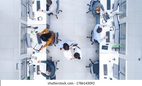 Top Down Shot of Big Busy Corporate Office with Tow Rows off Businessmen and Businesswomen Working on Desktop Computers. Bright Open Space Office with Businesspeople and Salespeople - Powered by Shutterstock