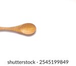 A Top Down Shot of A Spoon isolates on white backround. One empty wooden spoon isolated on white, top view. traditional kitchen set made from wood