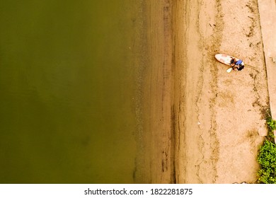 A top down shot taken directly over a woman who was preparing to take out her kayak. It is a cloudy morning on the shore of the Hudson River in upstate New York. - Powered by Shutterstock