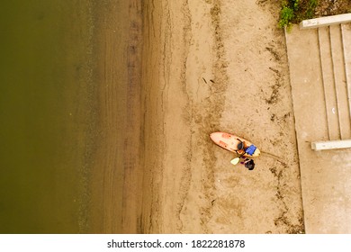 A top down shot taken directly over a woman who was preparing to take out her kayak. It is a cloudy morning on the shore of the Hudson River in upstate New York. - Powered by Shutterstock